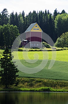 Colorful barn at the shore of lake