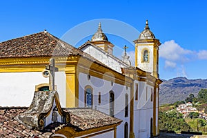 Colorful baroque church with mountains in the background