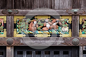 A colorful bas relief portraying the Three Wise Monkeys