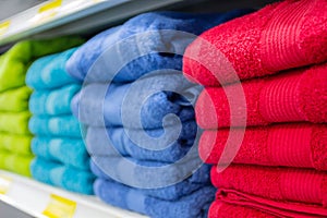 Colorful bath towels on the counter of the store close up