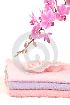 Colorful bathroom set with towels and orchid