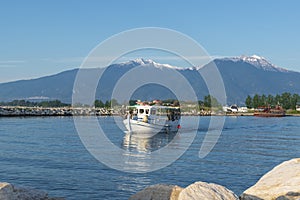 Colorful bay with fishing boats and a view of Mount Olympus in the background. Katerini Paralia beach, Pieria, Greece