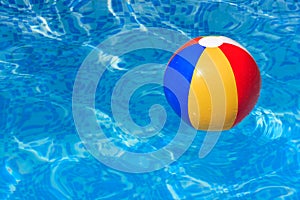 A colorful beach ball in swimming pool