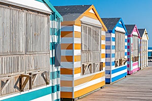 Colorful beach cabanas taken at the beach in Hastings, UK.