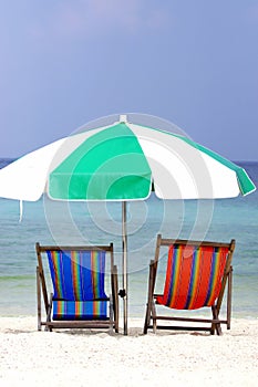 Colorful beach chairs and umbella in sunlight on the sand beach