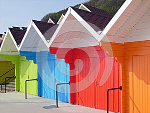 Colorful beach chalets by seaside photo