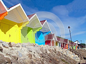 Colorful beach chalets by seaside