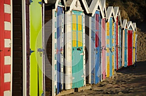 Colorful beach huts all in a row.