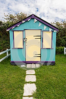 Colorful beach side huts on Devon coast of England