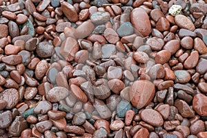 Colorful beach stones in the waves along the North Shore of Lake Superior, closeup, Minnesota, North Shore, background, texture