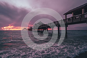 Colorful beach sunset across a pier in Clearwater, Florida