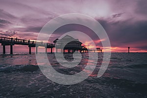 Colorful beach sunset across a pier in Clearwater, Florida