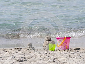 Colorful beach toys on a sandy beach