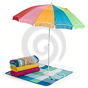 Colorful beach umbrella with matching towels photo