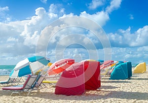 Colorful Beach umbrellas/parasols and cabanas near ocean