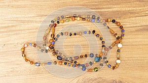 colorful bead necklace made of wood on wooden table