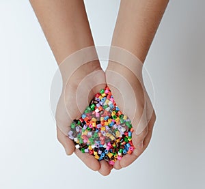 Colorful beads in child`s hands