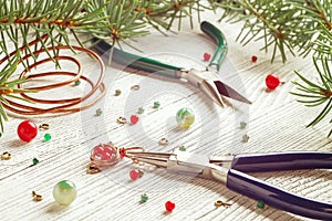 Colorful beads, copper wire and jewelry tools. Wire wrap. Christmas mood