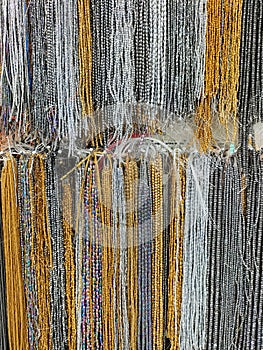 Colorful beads hanging in rows on the wall