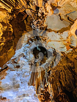Colorful beautiful cave interior with ancient stalactites and stalagmites. Wild nature