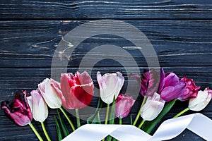 Colorful beautiful pink violet tulips on gray wooden table. Valentines, spring background. floral mock up.