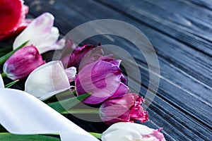 Colorful beautiful pink violet tulips on gray wooden table. Valentines, spring background. floral mock up. with copyspace.