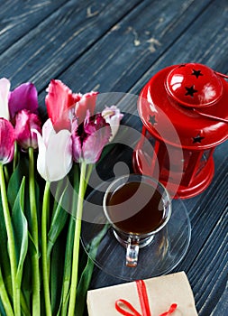 Colorful beautiful pink violet tulips and red lantern on gray wooden background. Valentines, spring background.