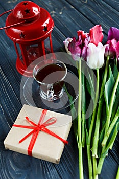 Colorful beautiful pink violet tulips and red lantern on gray wooden background. Valentines, spring background. floral mock up