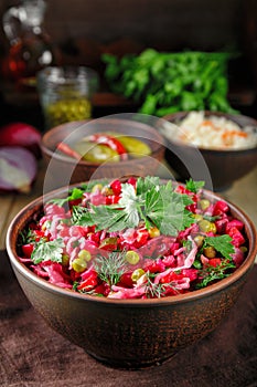 Colorful beetroot salad vinaigrette in a clay bowl