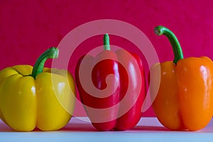 Colorful bell peppers in front of a colorful background