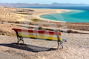 Colorful bench to contemplate View in Playa de Sotavento, Fuerteventura in Spain in summer photo