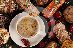 Colorful berry eclairs and coffee cup