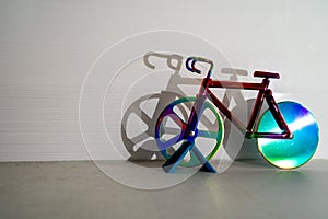 colorful bicycle and visible shadow, creative effect of sunlight, reflection on the wall