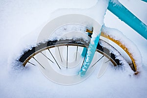 Colorful bike covered with snow.