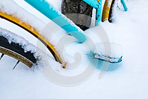 Colorful bike covered with snow.