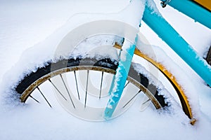 Colorful bike covered with snow.