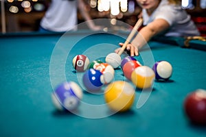Colorful billiard balls on table in pub macro photo. Gambling concept