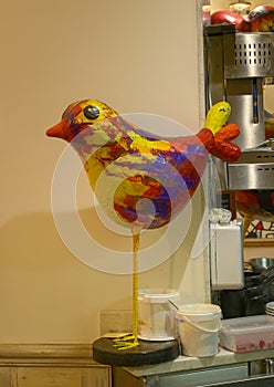Colorful bird sculpture inside Le Bar des Oiseaux, on a narrow backstreet in old town, Nice, France photo