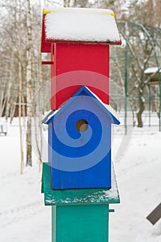 Colorful birdhouses for the birds in snow.