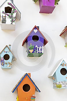 Colorful birdhouses close-up. Hanging on the wall.