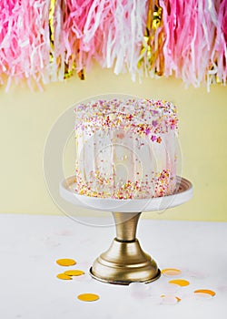 Colorful birthday cake with sprinkles on a yellow background with space for text. Party concept. Mother`s Day, Birthday Cake card