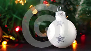 Colorful blinking lights behind white little Christmas ornament for Christmas tree