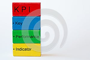 Colorful blocks with the words key, performance, indicator and on top a red block with the letters KPI. The background is isolated