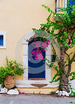 Colorful blue door of traditional greek house with yellow walls at Asos village. Assos peninsula famous and extremely