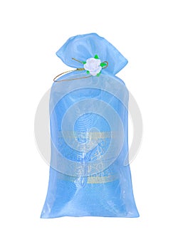 Colorful blue fabric gift bag with flowers isolated on white background with clipping path