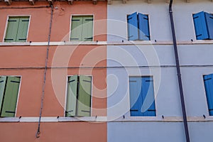 Colorful blue and green italian windows on colored houses