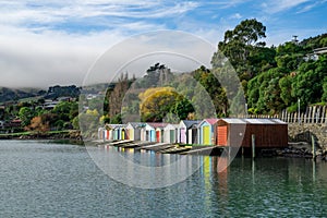 Colorful Boat Sheds with beautiful reflection on daytime  at Duvauchelle, Akaroa Harbour on Banks Peninsula in South Island, New