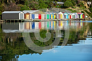 Colorful Boat Sheds with beautiful reflection on daytime  at Duvauchelle, Akaroa Harbour on Banks Peninsula in South Island, New