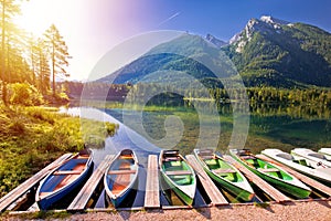 Colorful boats on Hintersee lake in Berchtesgaden Alpine landscape sunrise view
