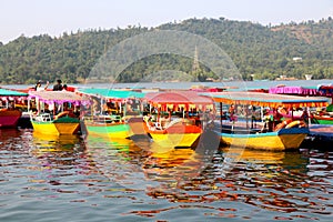 Colorful boats park at river bank photo